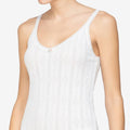 White tank top worn by a person on a plain background